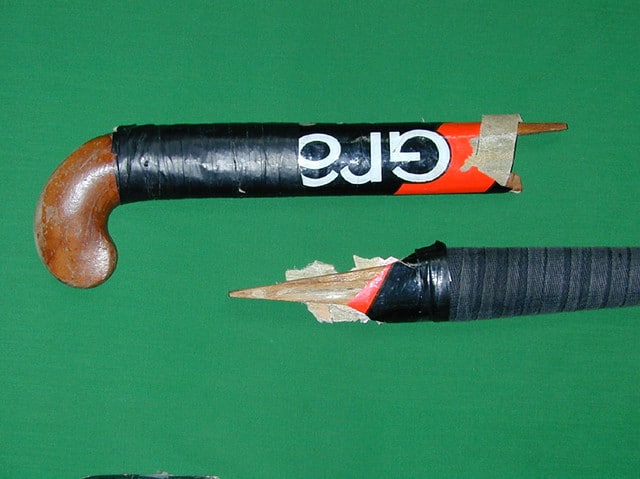 a broken wooden hockey stick. this is the past, but the future of field hockey looks bright with composite sticks.