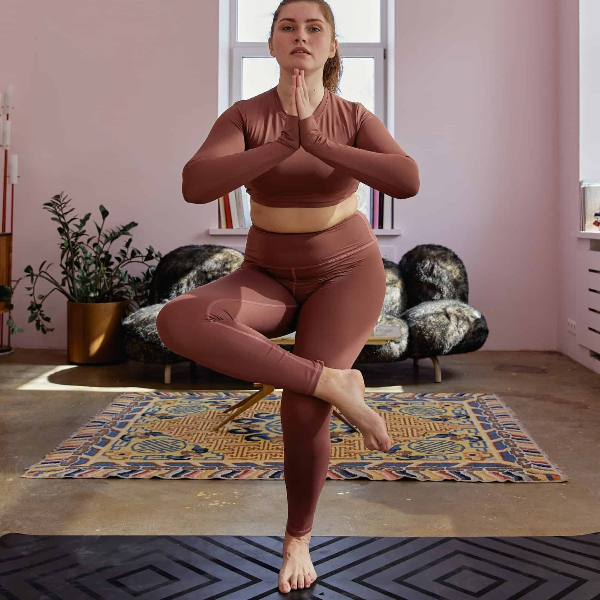 woman balancing on one leg to strengthen her ankle muscles.